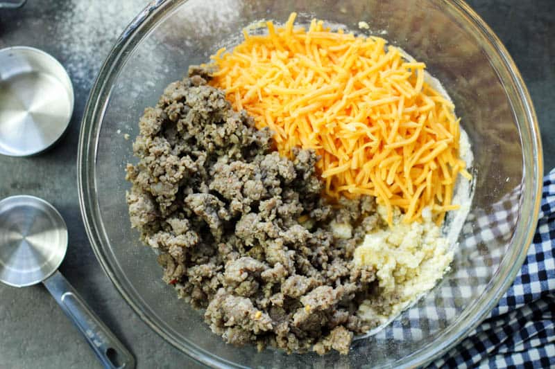 Ground sausage, cheese, and almond flour in a glass bowl