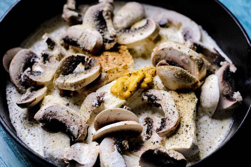 Mushrooms and mustard in pan