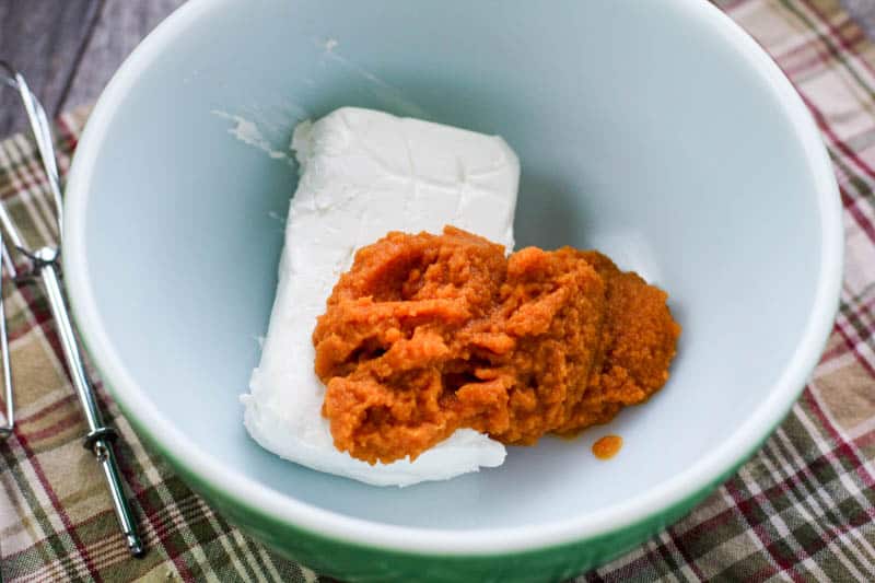 Cream cheese and pumpkin puree in a bowl to make Low Carb Pumpkin Cheesecake Fat Bombs