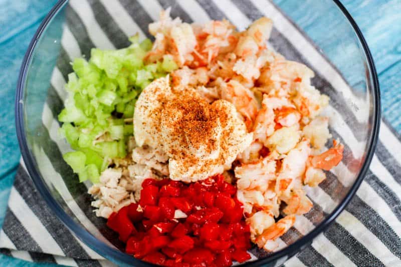 shrimp and chicken salad mixture in glass bowl