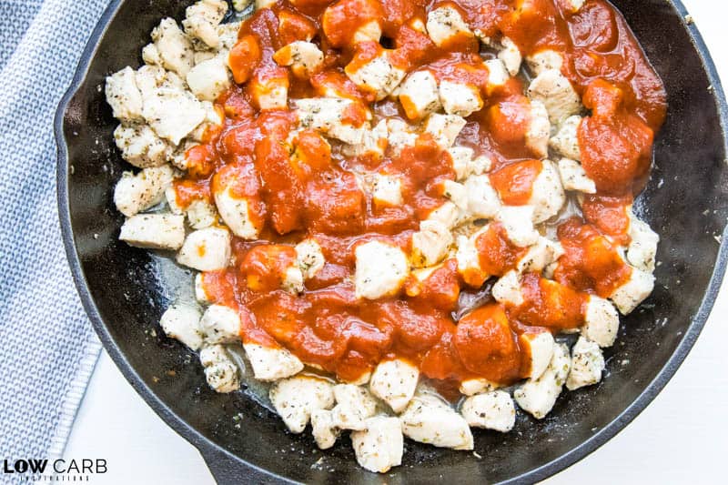 cooked chicken with sauce in a cast iron skillet