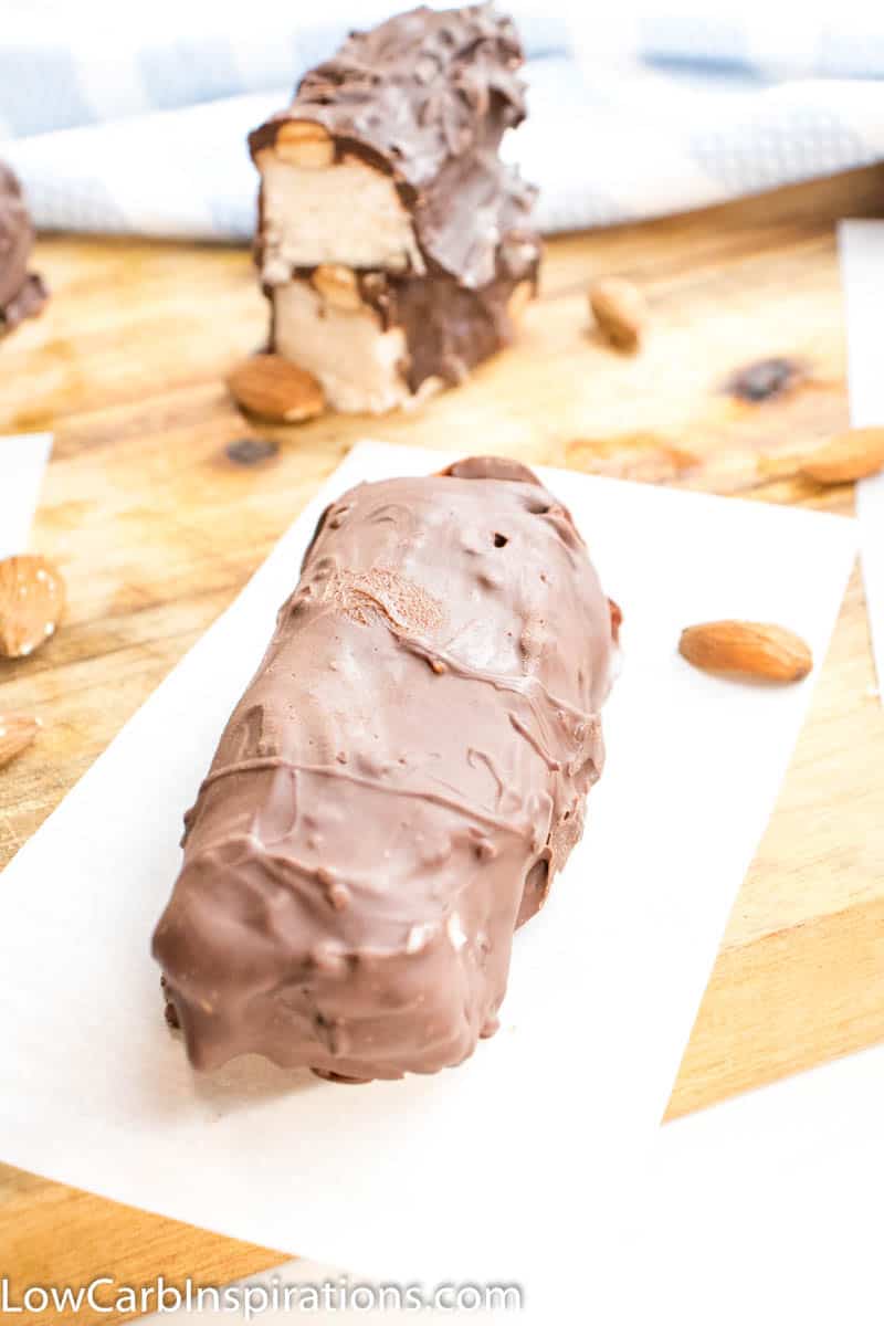 Almond Joy Fat Bombs laying on a cutting board with blue and white cloth in the background