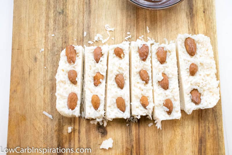 Frozen keto bombs sliced and ready to dip into chocolate