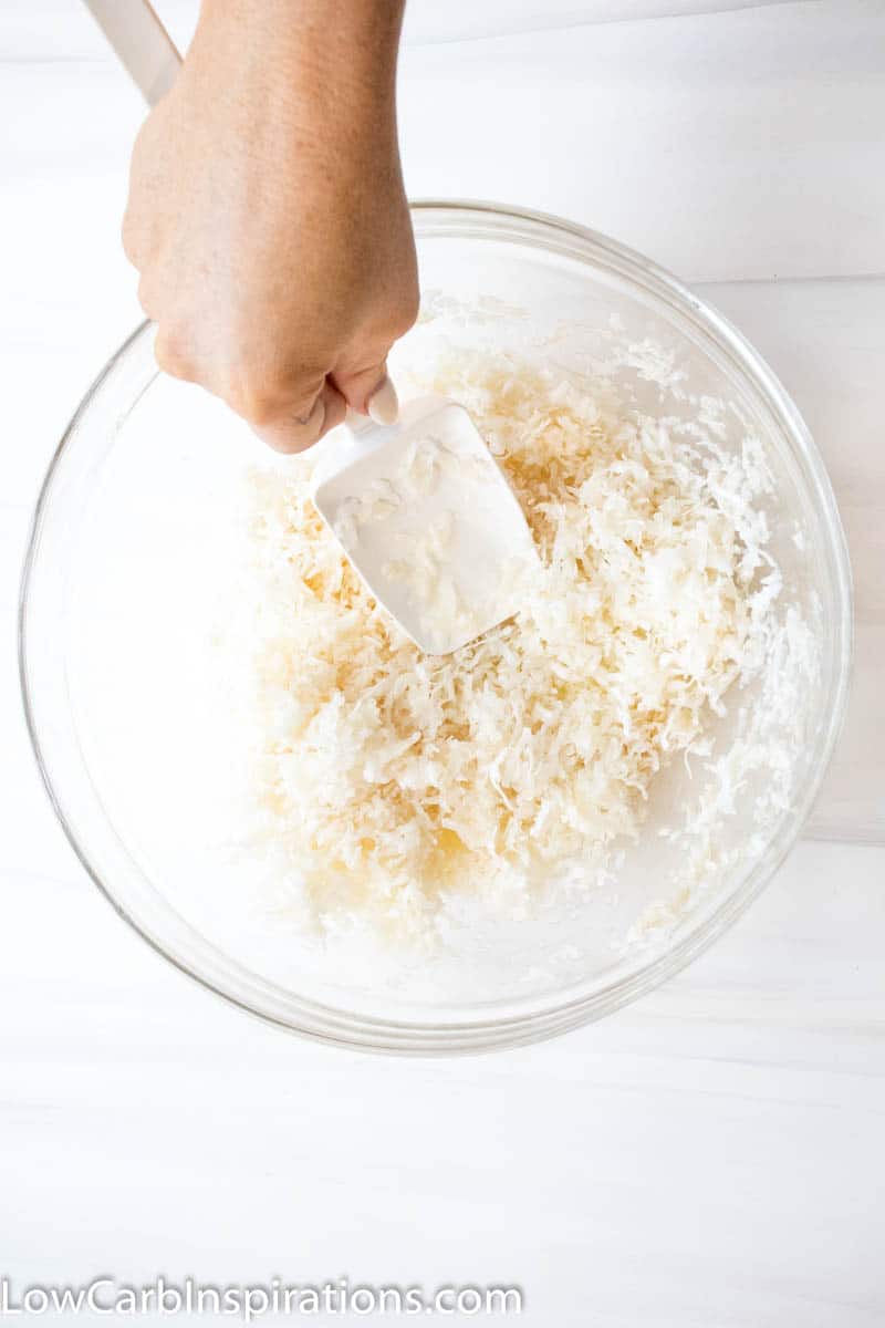 Mixing ingredients in a large glass bowl for the base of the almond joy fat bombs