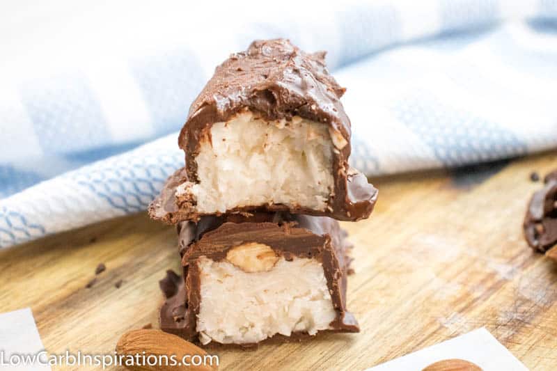 Up close picture of almond joy fat bombs cut in half showing the almond and filling