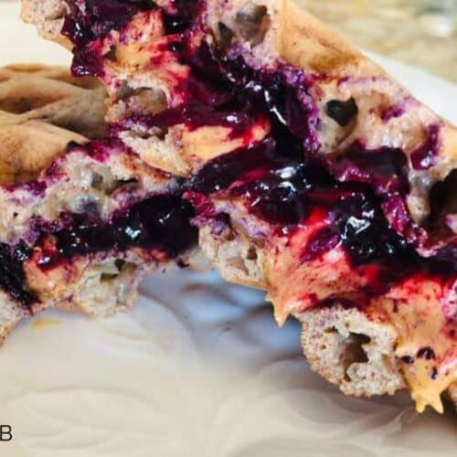 Made with cinnamon chaffle bread and blueberry compote, this Peanut Butter and Jelly Sammich Chaffle is going to make you love being on the keto diet even more!
