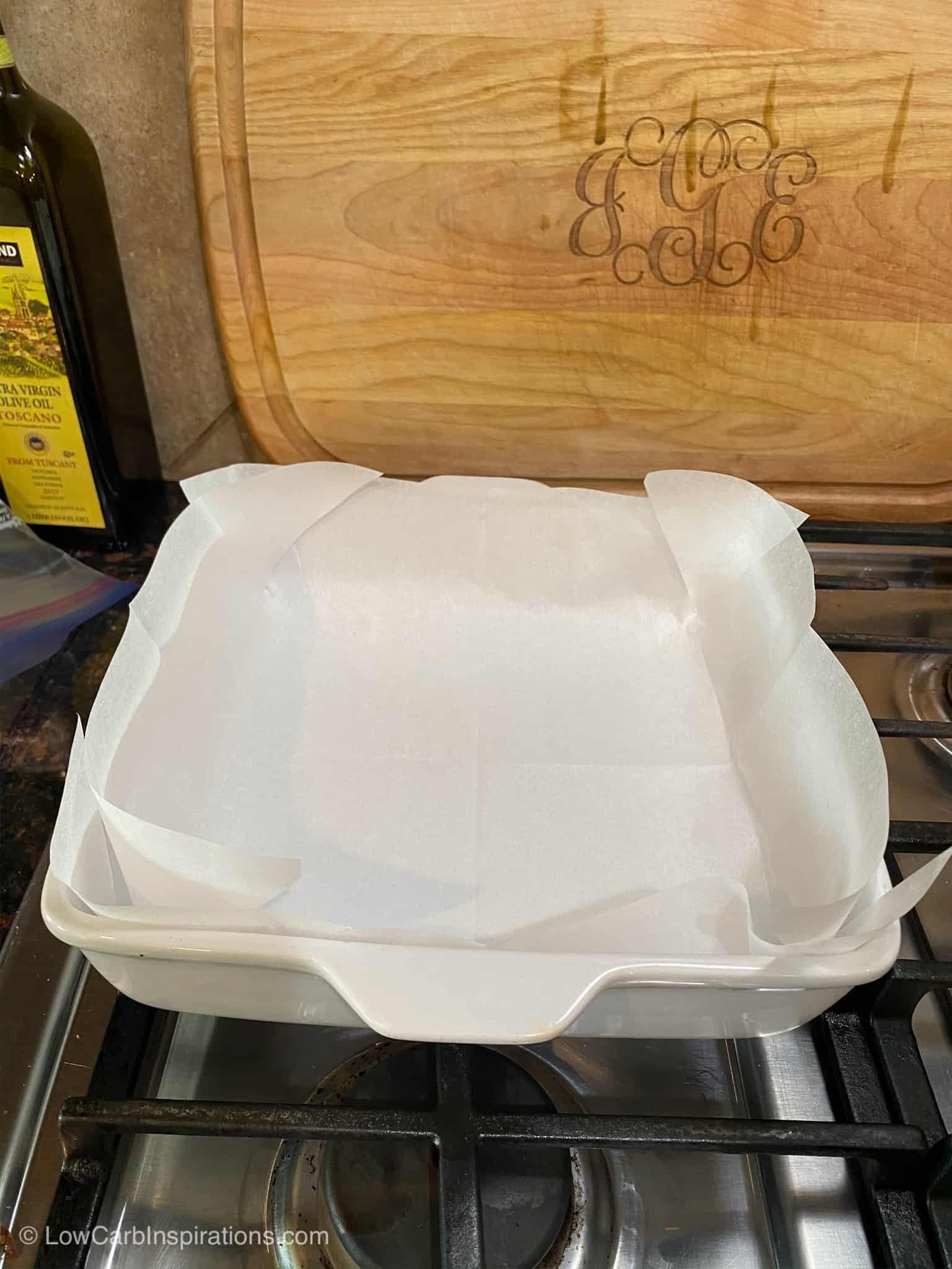 Parchment paper placed in a white square pan