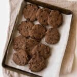 overhead photo of almond flour chocolate cookies on a baking sheet