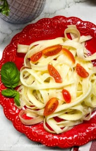 Buttered pasta noodles with cherry tomatoes and basil