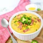 Keto Bacon Cheddar Soup Recipe in a white bowl on a table ready to eat