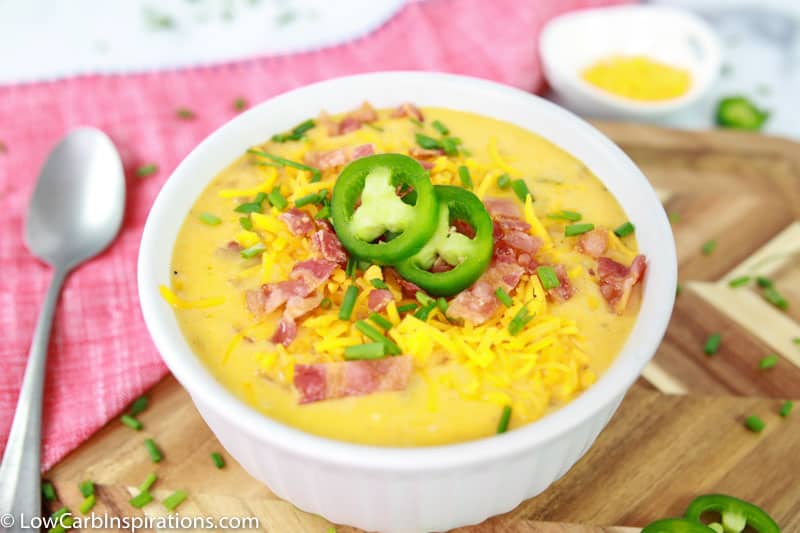 Keto Bacon Cheddar Soup Recipe in a white bowl with bacon, chives and jalapenos on top in a white bowl