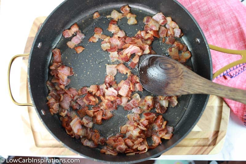 fully cooked bacon in a cast iron skillet