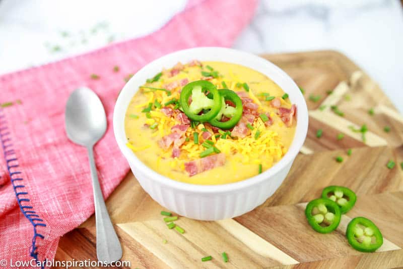 overhead photo of Keto Bacon Cheddar Soup Recipe in a white bowl on a table ready to eat