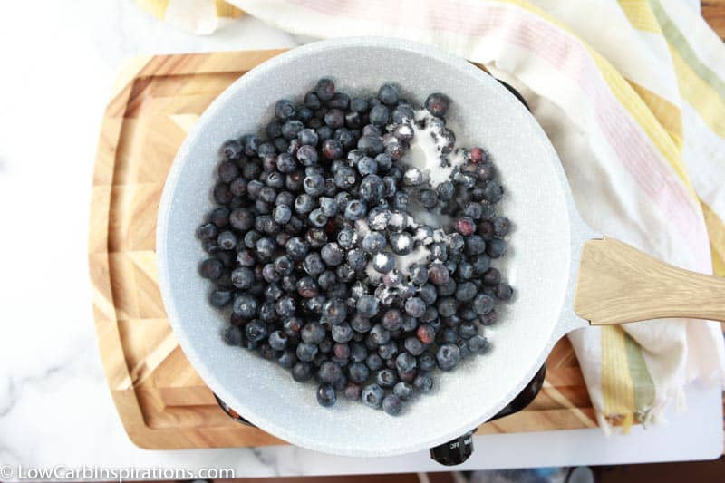 blueberries and keto sweetener in a white bowl on a table