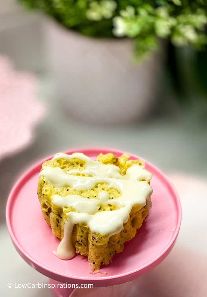Close up of yellow cake on pink cake stand