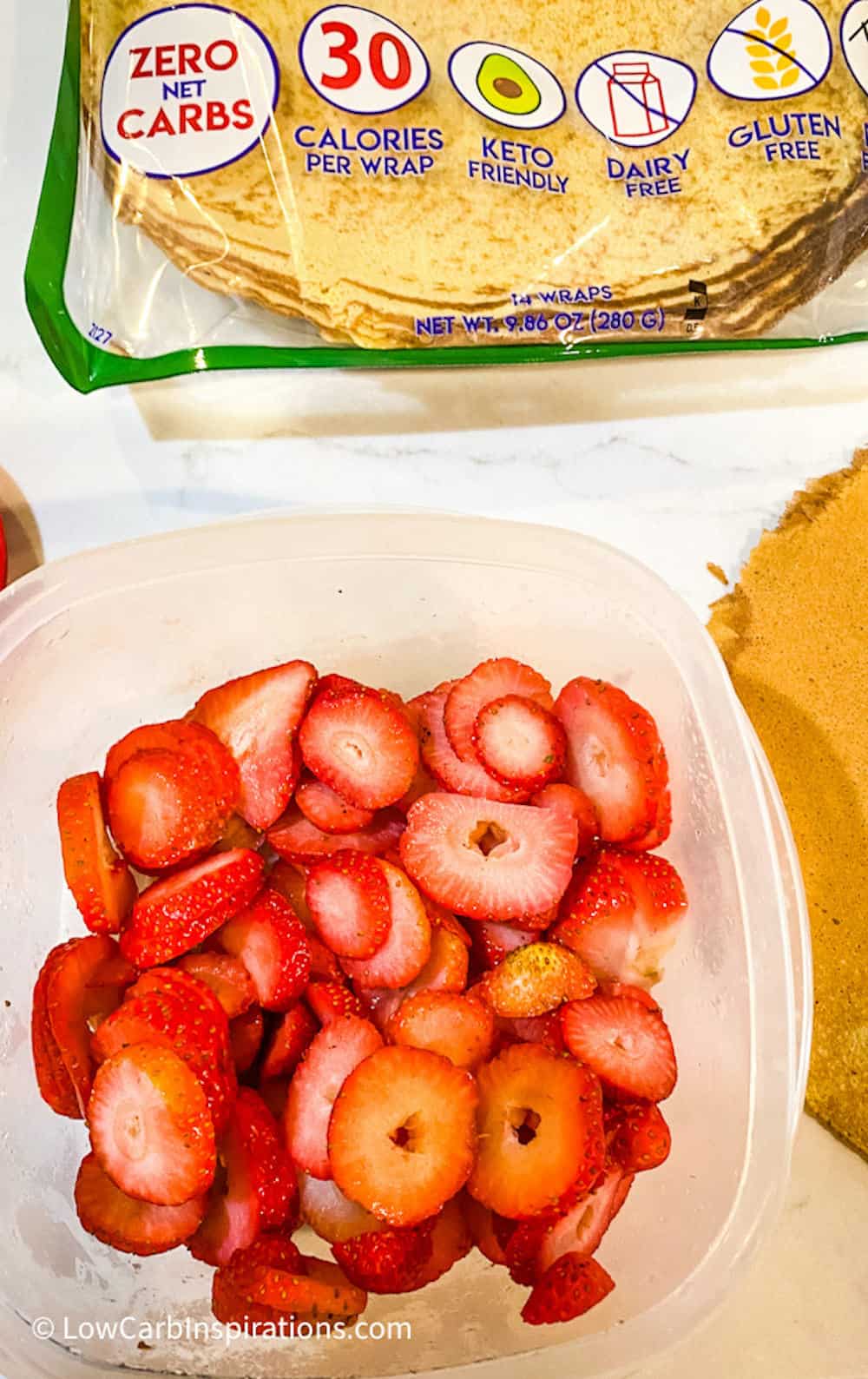 Strawberries diced in a plastic storage container