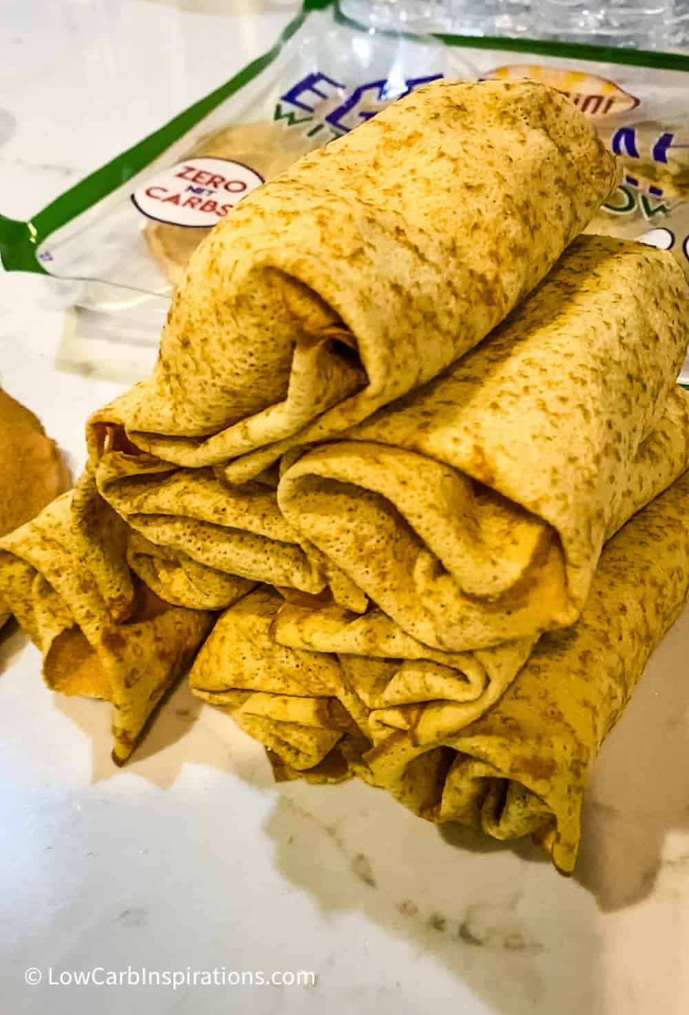 Wrapped Crepini Egg Thins stacked on the counter raw before frying them