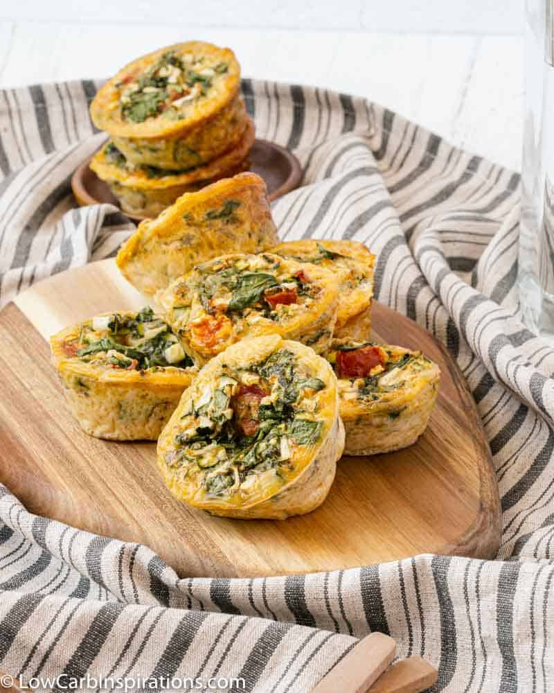 close up of stacked egg muffins on a wood cutting board