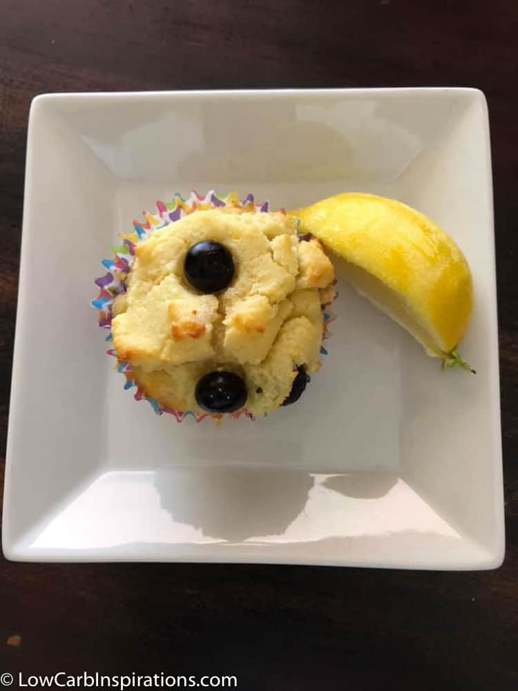 Lemon Blueberry Muffins on a white plate with a lemon slice