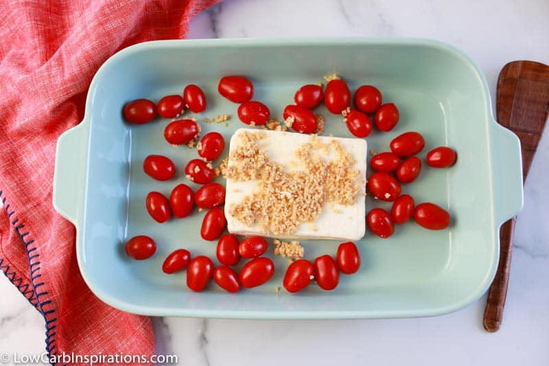 feta cheese block, cherry tomatoes and minced garlic in a casserole dish