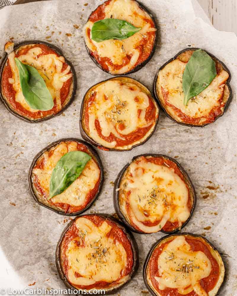 overhead close up photo of Mini Eggplant Margherita Pizza Recipe on a baking sheet with parchment paper