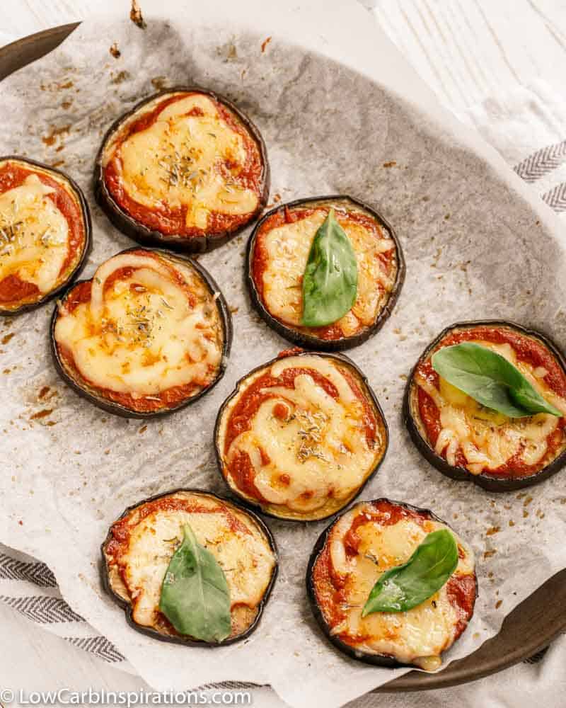 overhead photo of Mini Eggplant Margherita Pizza Recipe on a baking sheet with parchment paper