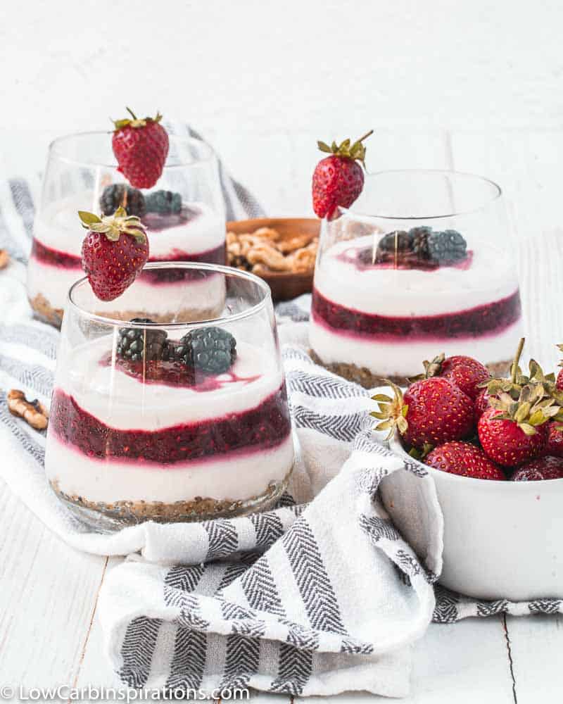 yogurt parfait recipe on a table with strawberries next to it and more parfaits in the background