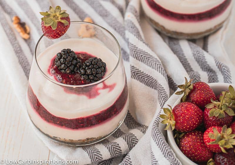 overhead photo of yogurt berry parfait with strawberries next to it