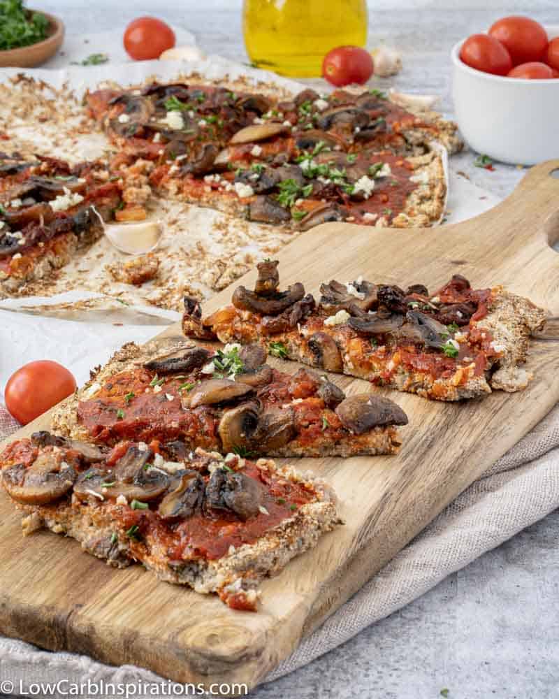 close up of Mushroom Pizza Recipe with Cauliflower Crust on a wood serving board