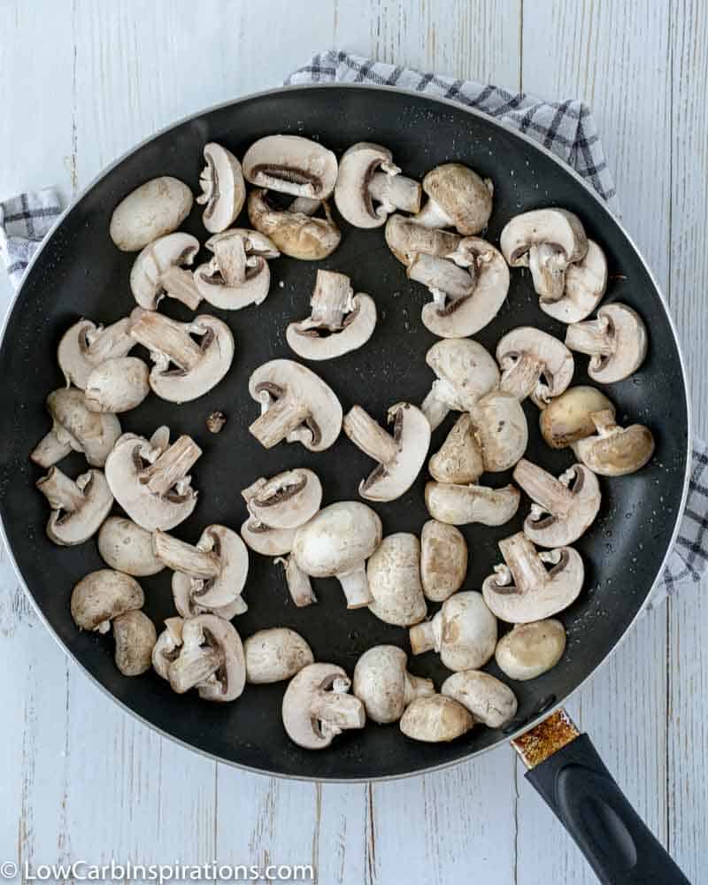 sliced mushrooms in a skillet cooking