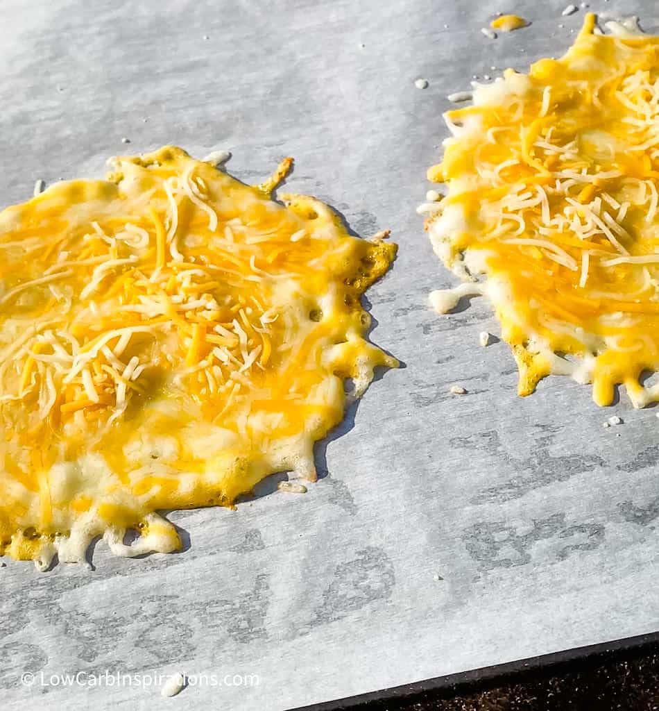 Cheese Taco Shells Recipe Ingredients Slices of your favorite cheese or shredded cheese Parchment paper for a non stick surface Equipment Needed Griddle or Frying Pan Cheese Taco Shells Recipe Instructions Preheat the griddle or frying pan over medium heat. Lay a slice of cheese or shredded cheese in a circle form layer with enough cheese not to see the bottom of the parchment paper.   Bake until the bottom forms a nice golden crust and the cheese has fully melted and is bubbling. To flip the cheese or not:  You can flip the cheese to cook the other side.  Just be sure you have enough room on the parchment paper to flip the cheese shell.  It's not require to flip the cheese for this technique to work. Soft cheese shell:  Only cook the cheese long enough for it to be fully melted and bubbly without changing color then pull from the heat. Crispy cheese shell:  Cook on both sides and allow the cheese to be fully melted and bubbling and then wait for the cheese to show a golden brown color.   Remove the shell from the heat and allow it to cool to a warm temperature before using the cheese taco shell.  You can even grab the corners of the parchment paper and place the hot cheese shell into a taco holder so that it cools in the taco shape! You can store them for later use by placing a piece of parchment paper between each cheese taco shell and placing it in the refrigerator until you are ready to use it.  It will keep for at least 5 days in the refrigerator.  I have not tried freezing them yet.   No need to buy Folios Cheese Wraps anymore because this is how you make your own!  We learned this when we microwaved cheese slices as seen in this recipe:  Homemade Cheese Wraps Recipe