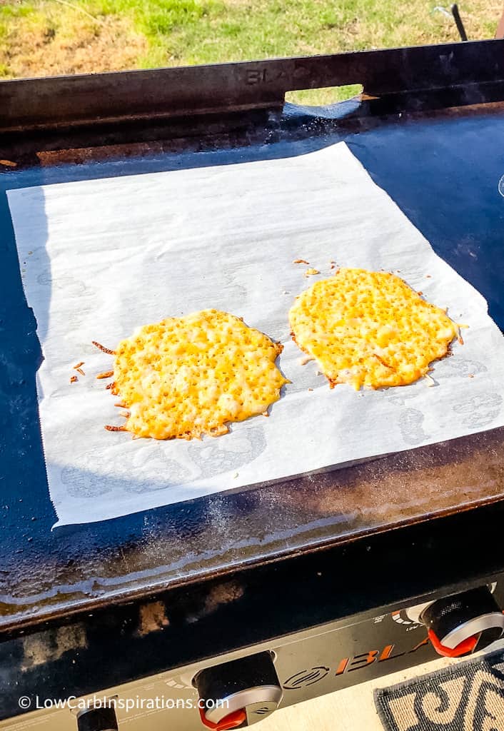 Cheese Taco Shells Recipe Ingredients Slices of your favorite cheese or shredded cheese Parchment paper for a non stick surface Equipment Needed Griddle or Frying Pan Cheese Taco Shells Recipe Instructions Preheat the griddle or frying pan over medium heat. Lay a slice of cheese or shredded cheese in a circle form layer with enough cheese not to see the bottom of the parchment paper.   Bake until the bottom forms a nice golden crust and the cheese has fully melted and is bubbling. To flip the cheese or not:  You can flip the cheese to cook the other side.  Just be sure you have enough room on the parchment paper to flip the cheese shell.  It's not require to flip the cheese for this technique to work. Soft cheese shell:  Only cook the cheese long enough for it to be fully melted and bubbly without changing color then pull from the heat. Crispy cheese shell:  Cook on both sides and allow the cheese to be fully melted and bubbling and then wait for the cheese to show a golden brown color.   Remove the shell from the heat and allow it to cool to a warm temperature before using the cheese taco shell.  You can even grab the corners of the parchment paper and place the hot cheese shell into a taco holder so that it cools in the taco shape! You can store them for later use by placing a piece of parchment paper between each cheese taco shell and placing it in the refrigerator until you are ready to use it.  It will keep for at least 5 days in the refrigerator.  I have not tried freezing them yet.   No need to buy Folios Cheese Wraps anymore because this is how you make your own!  We learned this when we microwaved cheese slices as seen in this recipe:  Homemade Cheese Wraps Recipe