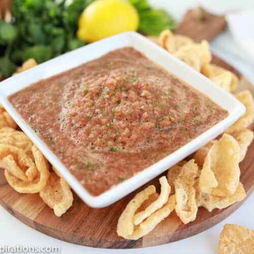 easy blender salsa recipe in a square white bowl with chips on the side of a plate