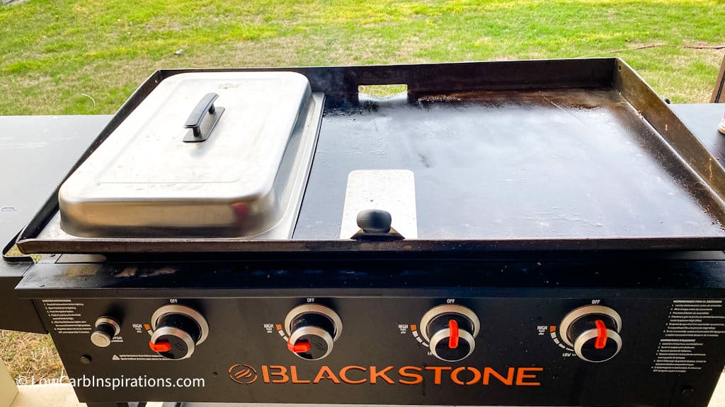 Blackstone griddle grill, cooking cover, and a spatuala