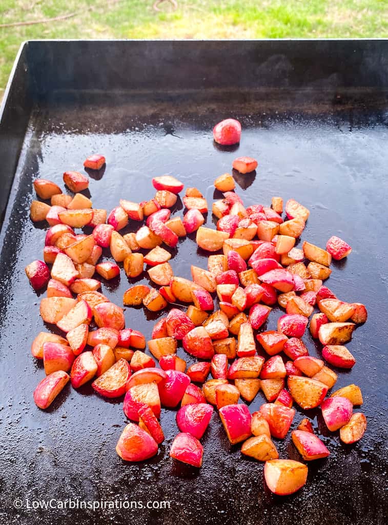 Radishes cooking on the griddle grill