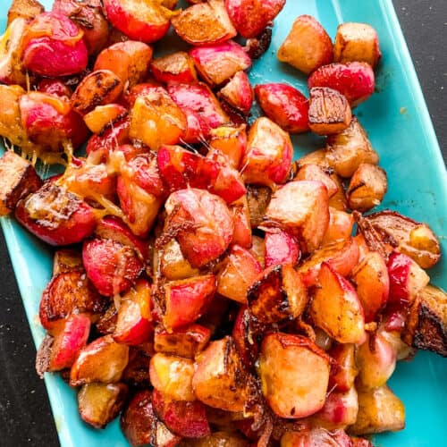 Fully grilled radishes served on a blue serving tray