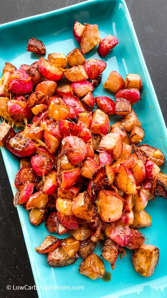 Fully grilled radishes served on a blue serving tray