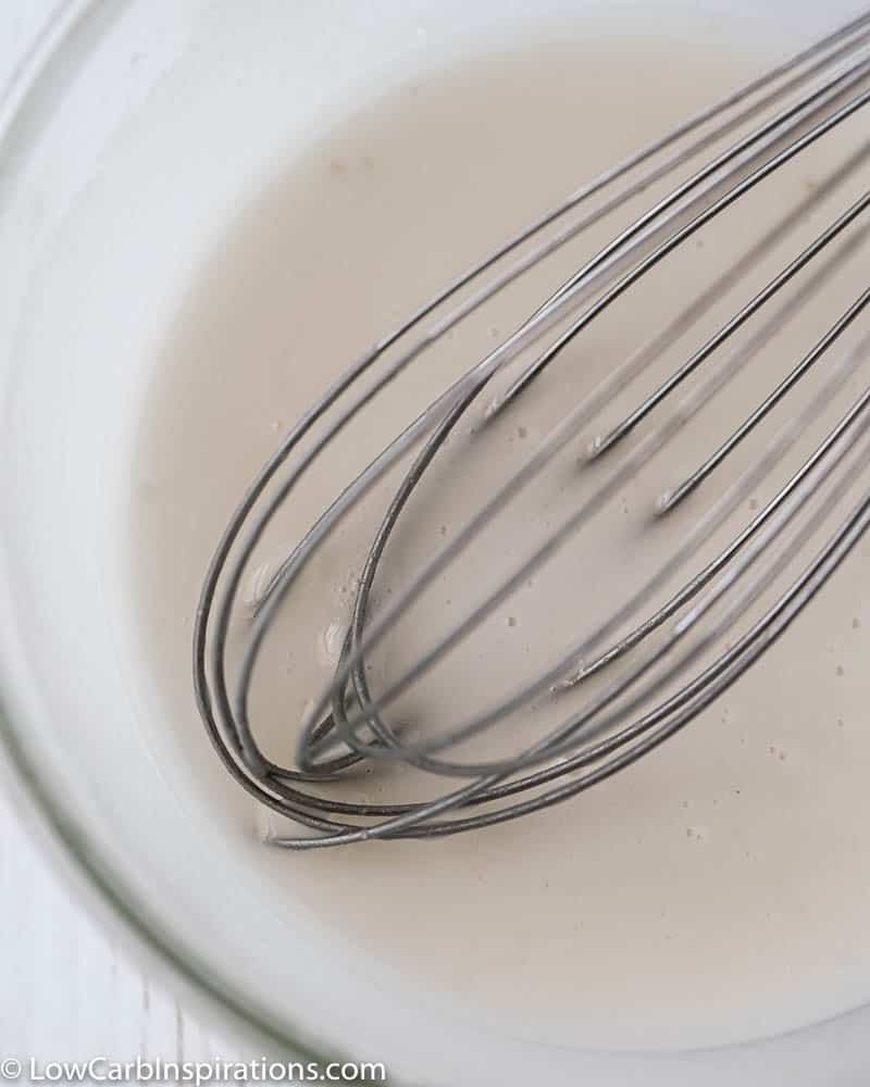 close up of sugar free glaze whisked together in a clear bowl
