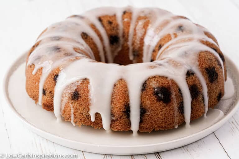 close up of finished lemon blueberry pound cake on a white plate on a table