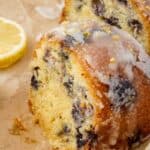 close up of keto lemon blueberry cake sliced on brown parchment paper