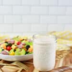 keto ranch dressing recipe in a mason jar with a salad in the background