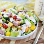 close up of keto salad dressing recipe on a salad with ranch dressing in the background