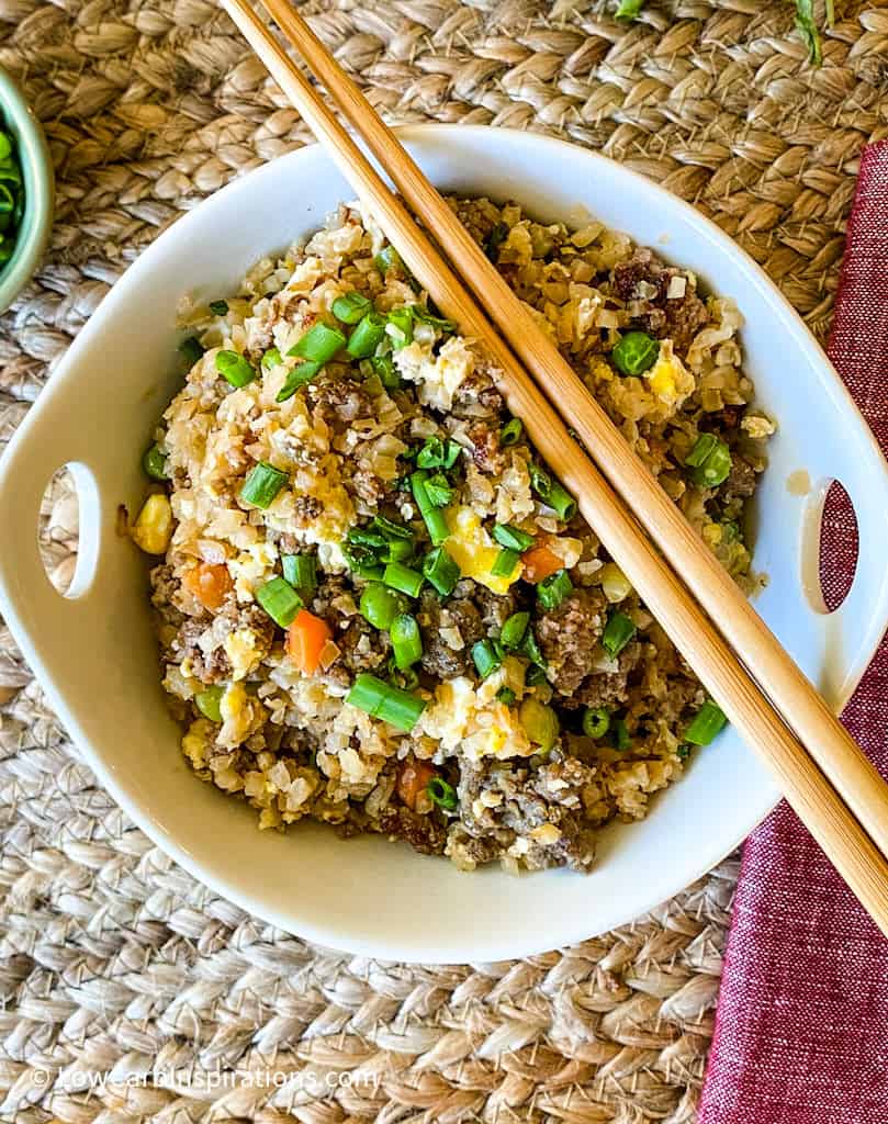 Bowl of fried rice with chopsticks and a red napkin