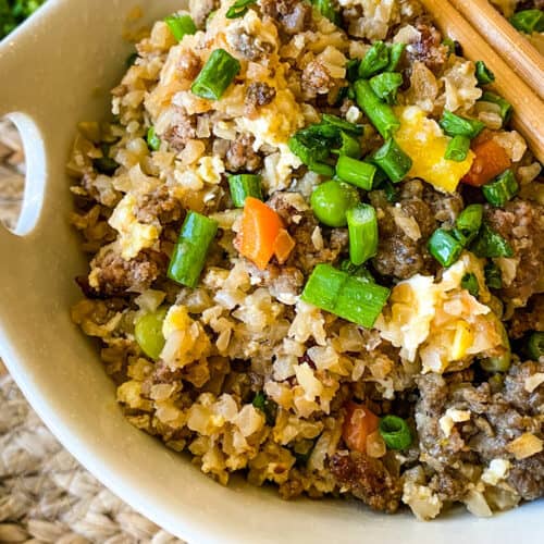 Close up of a bowl of fried rice with mixed veggies