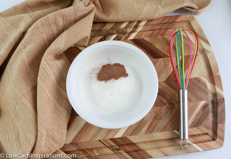 keto sweetener and cinnamon in a white bowl with a whisk on the side