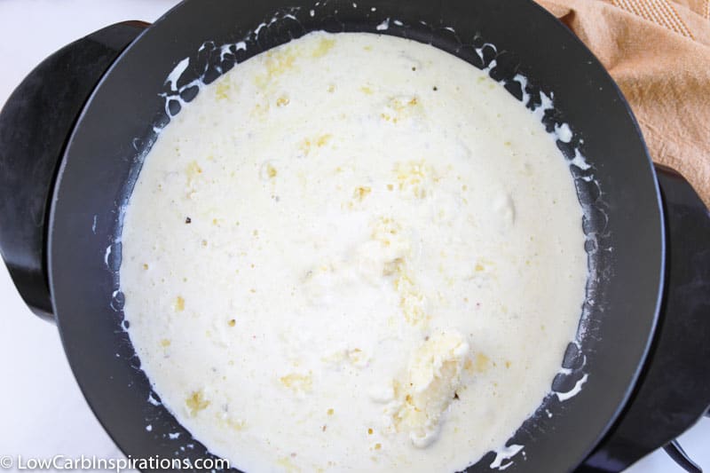 melting cheeses with heavy cream in a sauce pan