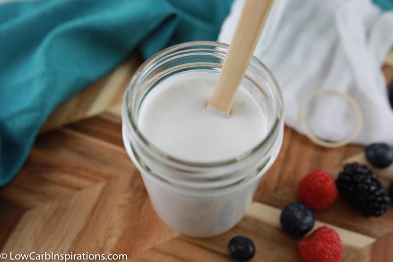 sugar free yogurt recipe mixed together in a mason jar with a wood spoon in the cup