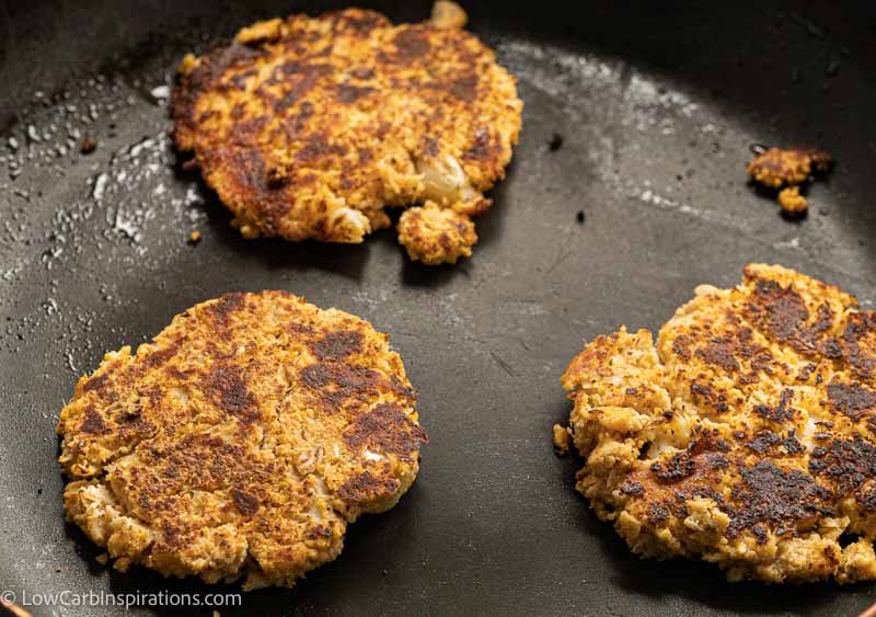 cauliflower savory pancakes in a skillet cooking