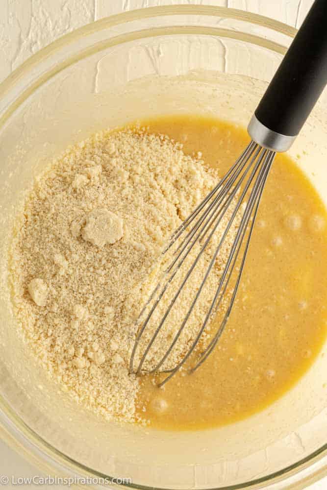 low carb blondies ingredients in a bowl with a whisk and almond flour